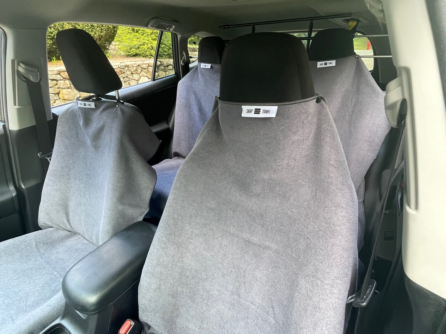 A full car all covered in Snap Towels, Ready for the next messy adventure, with no sacrifice to seat integrity or damage to your car's resell value!